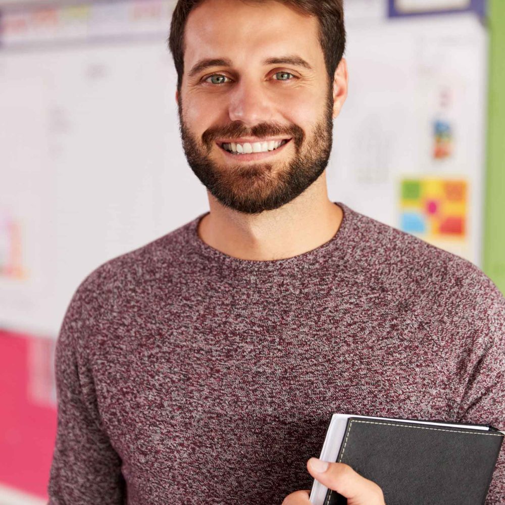 portrait-of-male-elementary-school-teacher-standin-HKVZWJS.jpg
